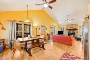 a living room with a table and a couch at Maple Gap Cabins - 66 Acre Nature Retreat with TWO Charming Cabins in Brevard