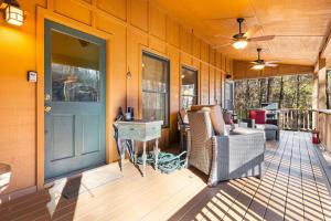 a porch of a house with a blue door and chairs at Maple Gap Cabins - 66 Acre Nature Retreat with TWO Charming Cabins in Brevard +76 photos