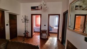 a living room with a couch and a mirror at Assisi - Appartamento Maristella in Santa Maria degli Angeli