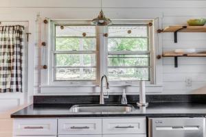 a kitchen with a sink and a window at Redwing Farm Cottage - Mountain Views and Firepit! in Bedford