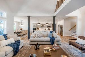 een woonkamer met een bank en een tafel bij Bass Cove - Luxury Lakefront, Hot Tub, Fire Table & Theatre! in Kasey