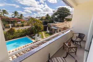 a balcony with a view of a swimming pool at Villa Araçà - Boutique Hotel in Lauro de Freitas