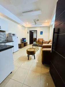 a living room with a couch and a table at Syed Apartment 104 in Islamabad +5 photos