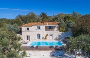 an exterior view of a house with a swimming pool at Kallista House in Kourtaíïka