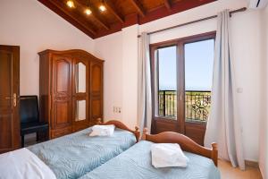 Postel nebo postele na pokoji v ubytování Villa Asteri