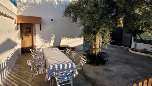 a table and chairs sitting next to a tree at Cortijo Atalaya de Loaimes in Granada