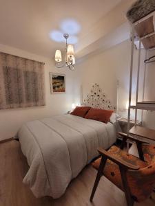 a bedroom with a large bed and a table at Cortijo Atalaya de Loaimes in Granada