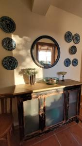 a mirror on a wall with plates on the wall at Cortijo Atalaya de Loaimes in Granada