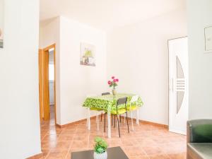 a dining room with a green table and chairs at Akivillas Lagos Zircon in Lagos