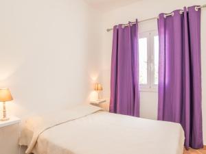 a bedroom with purple curtains and a bed at Akivillas Lagos Zircon in Lagos