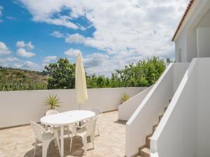 a patio with a white table and chairs at Akivillas Lagos Zircon in Lagos