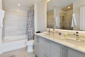 a bathroom with a sink and a toilet and a tub at Amazing Midtown 2 bdrm in Atlanta +18 photos
