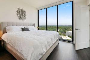 a bedroom with a large bed and a large window at Amazing Midtown 2 bdrm in Atlanta