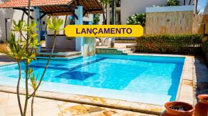 纳塔尔Sirius Beach Hotel的院子里有个游泳池，旁边立着一块牌子，上面写着“ianeammatio”。