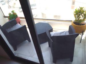 a room with two chairs and a window at La Rouah Mishkan in Dakar