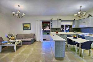 a kitchen and living room with a couch at Villa Thalassa next to the beach in Stavromenos
