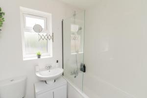 a white bathroom with a toilet and a sink at Contractors-Relocation-Free Parking-M5 Junction2 in Oldbury