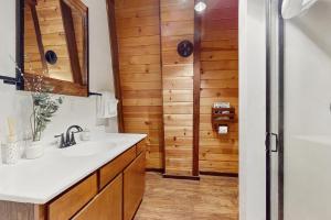 a bathroom with a sink and a shower at Charming Cabin in Bijou +11 photos