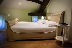 a bedroom with a large bed with a wooden headboard at Hotel Villa Nabila in Reggiolo +73 photos