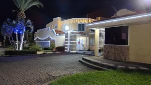 a house with lights on the side of it at night at Casa florida suite- seguridad y ubicación ideal in Ciudad Guayana