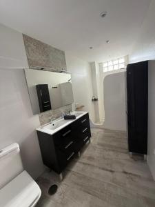 a bathroom with a sink and a toilet and a mirror at Villa Atlantic Marquesa - Punta Umbria in Punta Umbría +25 photos