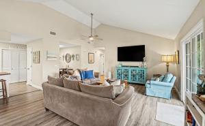 a living room with a couch and a flat screen tv at 359 Tarpon Blvd in Fripp Island