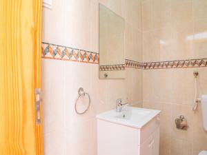 a bathroom with a sink and a toilet and a mirror at Akivillas Lagos Zircon in Lagos
