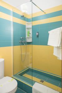 a bathroom with a glass shower with a toilet at Baroque Residence in Timişoara