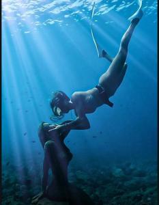 two people swimming in the water in the ocean at Reefside Retreat by B'lu Bamboo in Moalboal +3 photos