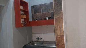 serenity apartments في مافكينج: حمام صغير مع حوض ومرآة