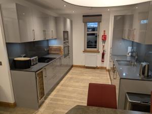 a kitchen with white cabinets and a counter top at Royal Gardens Apartment 10 in Dornoch