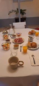 a table with plates of food and bowls of food at Château de Savignac-Mona in Savignac-Mona