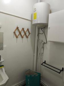 a bathroom with a water tank on the wall at Studio chambre salon cuisine in Dakar