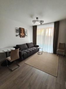 a living room with a couch and a table at Zen aeroport confort in Sînnicoară