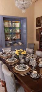 a dining room table with plates and dishes on it at Candelaria House Boutique in Bogotá