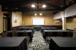 a room with tables and chairs and a projection screen at Aiden Austin City Hotel in Austin +78 photos