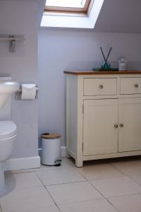 a bathroom with a toilet and a sink and a skylight at Charming 2 bed in Aberchirder in Aberchirder