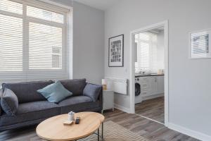 a living room with a couch and a table at Charming 2 bed in Aberchirder in Aberchirder +20 photos