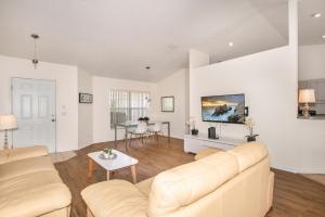 a living room with a couch and a table at Van Ness Poolhome - Lake access 2mi in Hernando