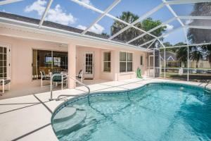 an indoor swimming pool with a glass ceiling at Van Ness Poolhome - Lake access 2mi in Hernando