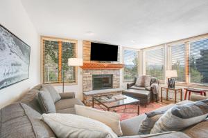 a living room with a couch and a fireplace at Tamarak 36 in Snowmass Village