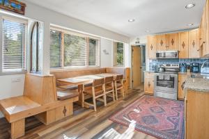 a kitchen with wooden cabinets and a table and a counter at Tamarak 36 in Snowmass Village