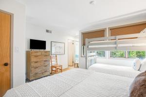 a bedroom with two beds and a bunk bed at Tamarak 36 in Snowmass Village +21 photos