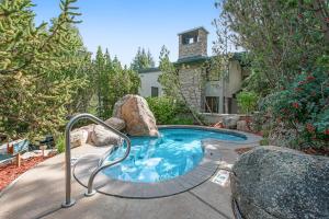 a small swimming pool with rocks in a yard at Tamarak 36 in Snowmass Village