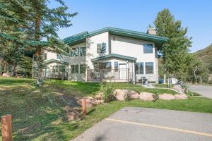 a large white house with a driveway at Tamarak 36 in Snowmass Village