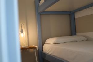 a bedroom with a bed and a lamp on a table at SUNSEA - Enjoy Your Family in Capo Vaticano