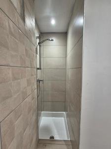 a bathroom with a shower with a tub at Grand appartement vue montagne in Ayzac-Ost +23 photos