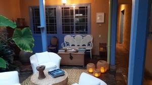 a living room with two white chairs and a table at Candelaria House Boutique in Bogotá +128 photos
