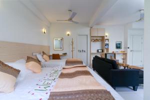 a large bedroom with a large bed and a couch at La Sky Stay in Ukulhas