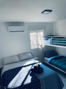 a bedroom with a bed and a bunk bed at Piso trabajo Rocafort 2 in Madrid